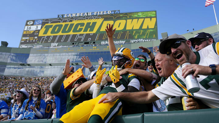 Sep 7, 2025; Green Bay, Wisconsin, USA; Green Bay Packers wide receiver Jayden Reed (11) celebrates with fans after scoring a touchdown against the Detroit Lions during the second quarter at Lambeau Field. Mandatory Credit: Jeff Hanisch-Imagn Images Sep 7, 2025; Green Bay, Wisconsin, USA; Green Bay Packers wide receiver Jayden Reed (11) celebrates with fans after scoring a touchdown against the Detroit Lions during the second quarter at Lambeau Field. Mandatory Credit: Jeff Hanisch-Imagn Images