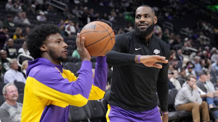 Los Angeles Lakers forward LeBron James (23) goofs around with his son guard Bronny James (9) during warm ups before their game against the Milwaukee Bucks at Fiserv Forum. Mandatory Credit: Michael McLoone-Imagn Images