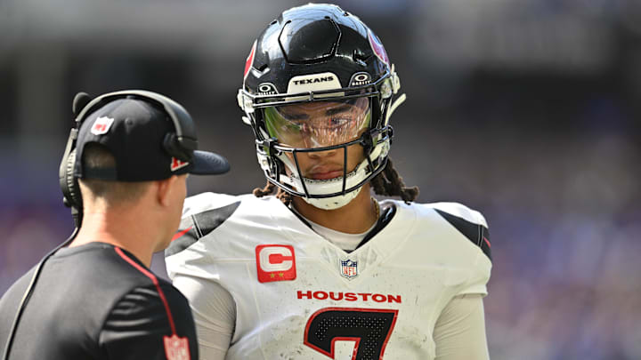 Sep 22, 2024; Minneapolis, Minnesota, USA; Houston Texans quarterback C.J. Stroud (7) talks with an assistant coach during the second quarter against the Minnesota Vikings at U.S. Bank Stadium. Mandatory Credit: Jeffrey Becker-Imagn Images