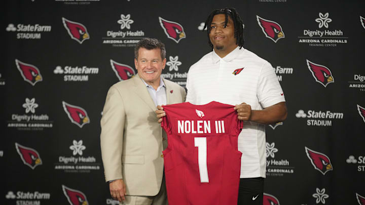 Cardinals defensive lineman Walter Nolen stands and holds his jersey with owner Michael Bidwill (left) during his introductory news conference inside the Arizona Cardinals training facility on April 25, 2025, in Tempe.