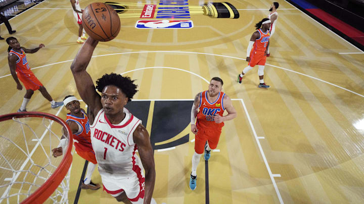 Dec 14, 2024; Las Vegas, Nevada, USA; Houston Rockets forward Amen Thompson (1) shoots against Oklahoma City Thunder guard Shai Gilgeous-Alexander (2) during the first half in a semifinal of the 2024 Emirates NBA Cup at T-Mobile Arena. Mandatory Credit: Kyle Terada/Pool Photo-Imagn Images