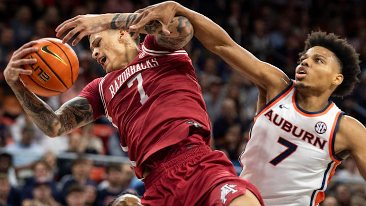 Auburn Tigers forward Keyshawn Hall (7) fouls Arkansas Razorbacks forward Trevon Brazile (7) as they fight for a rebound in a game at Neville Arena in Auburn, Ala.