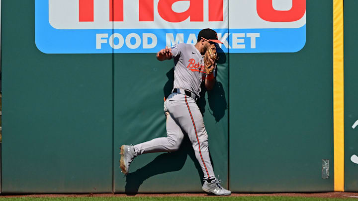 Baltimore Orioles right fielder Anthony Santander (25) hits the wall after catching a ball during the eighth inning against the Cleveland Guardians at Progressive Field in 2024.