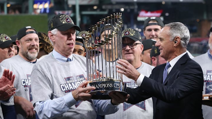 Nov 2, 2021; Houston, TX, USA; MLB commissioner Rob Manfred presents Atlanta Braves chairman Terry McGuirk with the Commissioner's Trophy after defeating the Houston Astros in game six of the 2021 World Series at Minute Maid Park. Mandatory Credit: Troy Taormina-Imagn Images