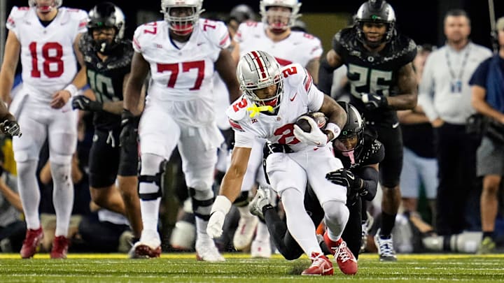 Oct 12, 2024; Eugene, Oregon, USA; Ohio State Buckeyes wide receiver Emeka Egbuka (2) gets tackled by Oregon Ducks defensive back Brandon Johnson (3) after a catch in the second half during the NCAA football game at Autzen Stadium