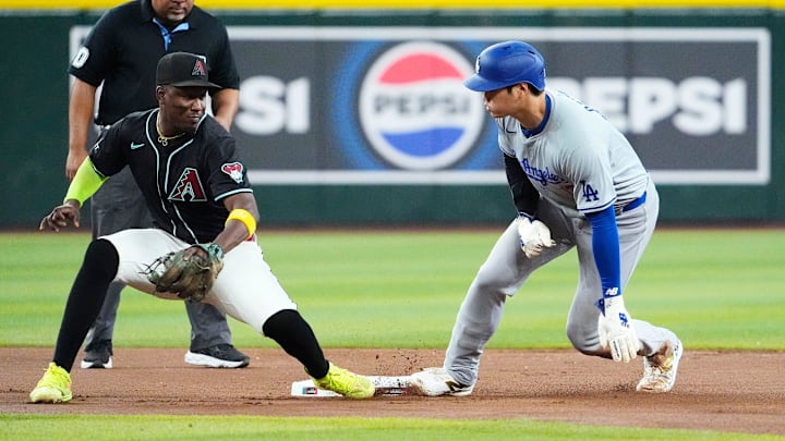 Los Angeles Dodgers Shohei Ohtani (17) steals second base against Arizona Diamondbacks shortstop Geraldo Perdomo (2) in the seventh inning at Chase Field on Sept. 2, 2024, in Phoenix.