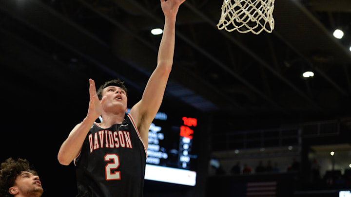 Feb 27, 2024; Dayton, Ohio, USA; Davidson forward Bobby Durkin (2) shoots the ball against Dayton Flyers forward Nate Santos (2) during the first half of the game at University of Dayton Arena. Mandatory Credit: Matt Lunsford-Imagn Images Feb 27, 2024; Dayton, Ohio, USA; Davidson forward Bobby Durkin (2) shoots the ball against Dayton Flyers forward Nate Santos (2) during the first half of the game at University of Dayton Arena. Mandatory Credit: Matt Lunsford-Imagn Images