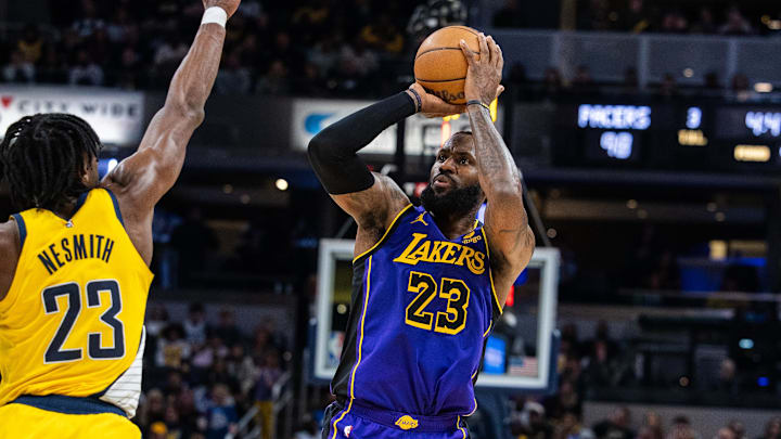 Mar 29, 2024; Indianapolis, Indiana, USA: Los Angeles Lakers forward LeBron James (23) shoots the ball while Indiana Pacers forward Aaron Nesmith (23) defends in the second half at Gainbridge Fieldhouse. Mandatory Credit: Trevor Ruszkowski-Imagn Images