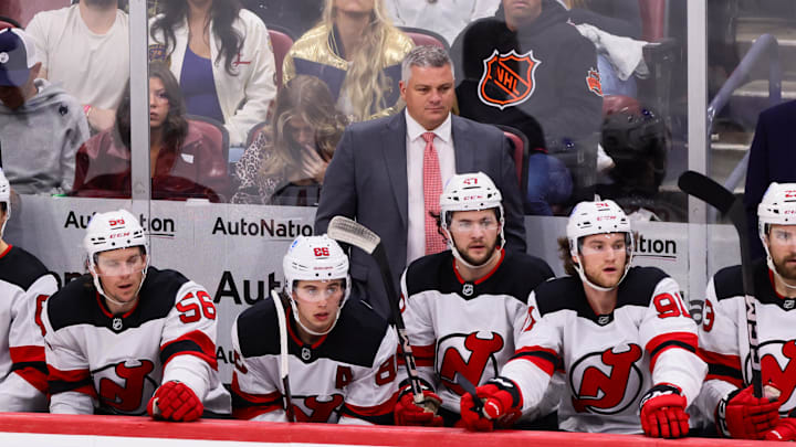 Nov 12, 2024; Sunrise, Florida, USA; New Jersey Devils head coach Sheldon Keefe watches from the bench against the Florida Panthers during the third period at Amerant Bank Arena. Mandatory Credit: Sam Navarro-Imagn Images