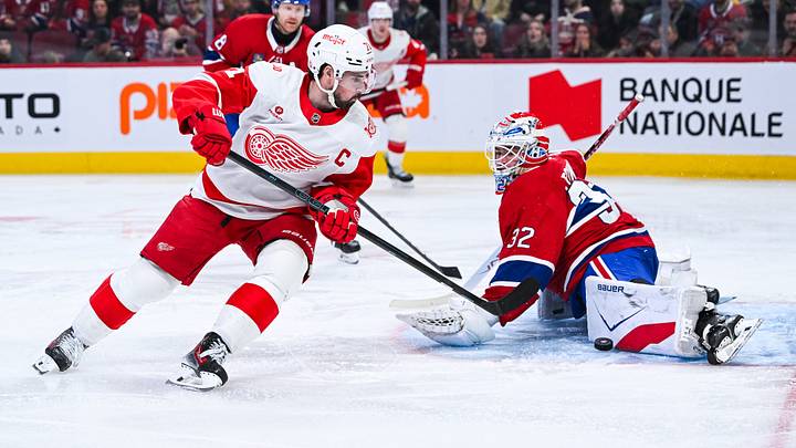Jan 10, 2026; Montreal, Quebec, CAN; Montreal Canadiens goalie Jacob Fowler (32) makes a save against Detroit Red Wings center Dylan Larkin (71) during the second period at Bell Centre. Mandatory Credit: David Kirouac-Imagn Images