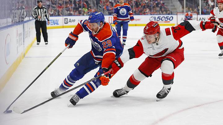 Mar 6, 2026; Edmonton, Alberta, CAN; Edmonton Oilers forward Leon Draisaitl (29) protects the puck from Carolina Hurricanes defensemen Alexander Nikishin (21) during the third period at Rogers Place. Mandatory Credit: Perry Nelson-Imagn Images
