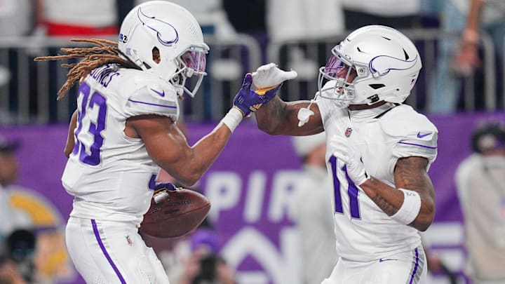 Dec 16, 2024; Minneapolis, Minnesota, USA; Minnesota Vikings running back Aaron Jones (33) celebrates his touchdown with wide receiver Trent Sherfield Sr. (11) against the Chicago Bears in the third quarter at U.S. Bank Stadium. 