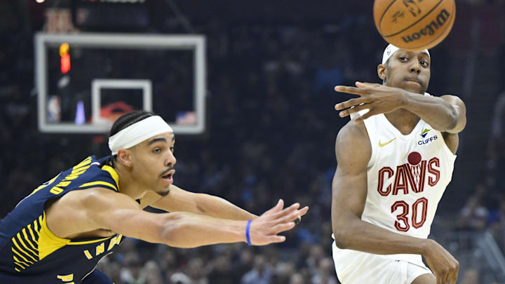 Apr 13, 2025; Cleveland, Ohio, USA; Cleveland Cavaliers forward Nae'Qwan Tomlin (30) throws a pass beside Indiana Pacers guard Andrew Nembhard (2) in the first quarter at Rocket Arena. Mandatory Credit: David Richard-Imagn Images