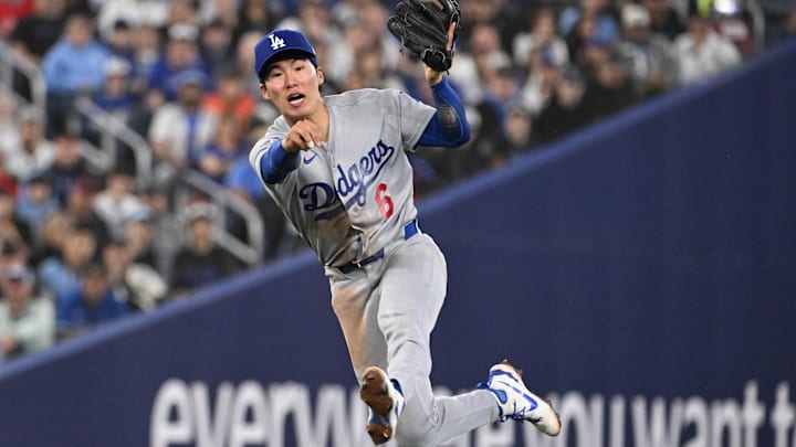 Apr 7, 2026; Toronto, Ontario, CAN;  Los Angeles Dodgers shortstop Hyeseong Kim (6) throws out Toronto Blue Jays center fielder Daulton Varsho (not shown) in the fifth inning at Rogers Centre. Mandatory Credit: Dan Hamilton-Imagn Images