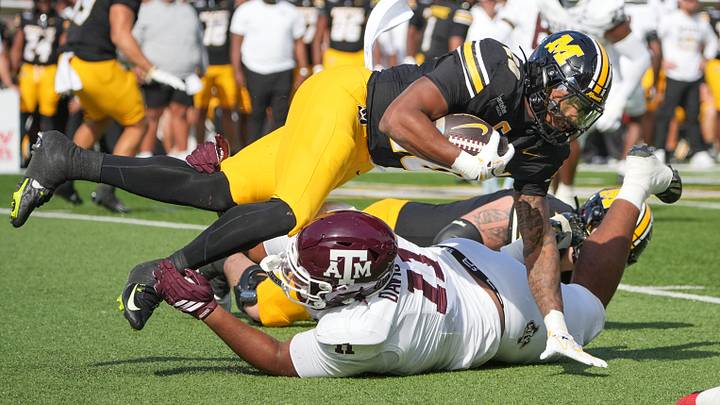 Missouri Tigers running back Jamal Roberts (20) runs the ball as Texas A&M Aggies defensive tackle Brandon Davis-Swain (11) makes the tackle during the first half of the game at Faurot Field at Memorial Stadium. Mandatory Credit: Denny Medley-Imagn Images Missouri Tigers running back Jamal Roberts (20) runs the ball as Texas A&M Aggies defensive tackle Brandon Davis-Swain (11) makes the tackle during the first half of the game at Faurot Field at Memorial Stadium. Mandatory Credit: Denny Medley-Imagn Images