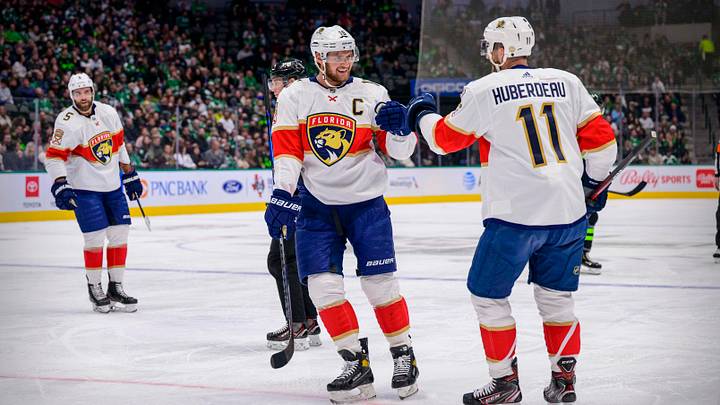 Florida Panthers defenseman Aaron Ekblad (5) and center Aleksander Barkov (16) and left wing Jonathan Huberdeau (11) celebrates a goal scored by Huberdeau against the Dallas Stars during the first period at the American Airlines Center. Mandatory Credit: Jerome Miron-USA TODAY Sports