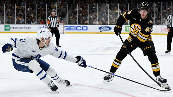 Nov 11, 2025; Boston, Massachusetts, USA; Toronto Maple Leafs defenseman Philippe Myers (51) defends Boston Bruins center Fraser Minten (93) during the third period at the TD Garden. Mandatory Credit: Brian Fluharty-Imagn Images