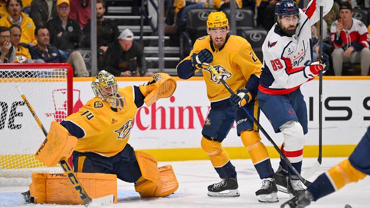 Oct 29, 2026; Nashville, Tennessee, USA; Nashville Predators goaltender Juuse Saros (74) blocks the puck as Nashville Predators defenseman Adam Wilsby (2) and Washington Capitals right wing Alex Tuch (89) fight for position during the first period at Bridgestone Arena. Mandatory Credit: Steve Roberts-Imagn Images Oct 29, 2026; Nashville, Tennessee, USA; Nashville Predators goaltender Juuse Saros (74) blocks the puck as Nashville Predators defenseman Adam Wilsby (2) and Washington Capitals right wing Alex Tuch (89) fight for position during the first period at Bridgestone Arena. Mandatory Credit: Steve Roberts-Imagn Images