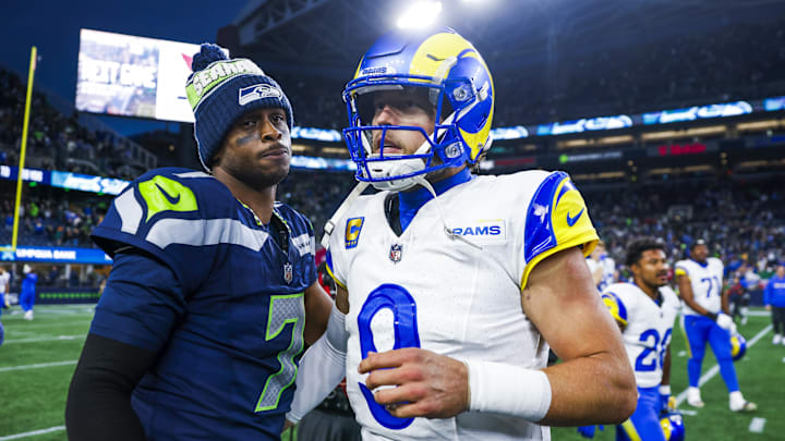 Nov 3, 2024; Seattle, Washington, USA; Seattle Seahawks quarterback Geno Smith (7) and Los Angeles Rams quarterback Matthew Stafford (9) greet each other following an overtime victory by the Rams at Lumen Field. Mandatory Credit: Joe Nicholson-Imagn Images