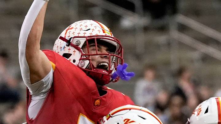 Kuemper Catholic’s Jack Badding (7) lifts Jarin Hoffman (5) into the air as the Knights celebrate their Class 2A state championship Nov. 21, 2025 after defeating the Van Meter Bulldogs at the UNI-Dome in Cedar Falls, Iowa. Kuemper Catholic’s Jack Badding (7) lifts Jarin Hoffman (5) into the air as the Knights celebrate their Class 2A state championship Nov. 21, 2025 after defeating the Van Meter Bulldogs at the UNI-Dome in Cedar Falls, Iowa.