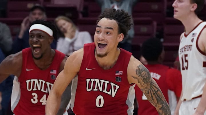 UNLV Runnin' Rebels guard Dra Gibbs-Lawhorn (0) and center Emmanuel Stephen (34) celebrate after the buzzer sounds as Stanford Cardinal forward/center Oskar Giltay (15) looks on in the second half at Maples Pavilion. Mandatory Credit: David Gonzales-Imagn Images