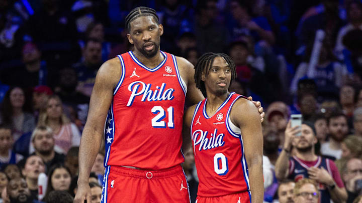 Apr 12, 2024; Philadelphia, Pennsylvania, USA; Philadelphia 76ers center Joel Embiid (21) huddles with Tyrese Maxey (0) in a game against the Orlando Magic. 