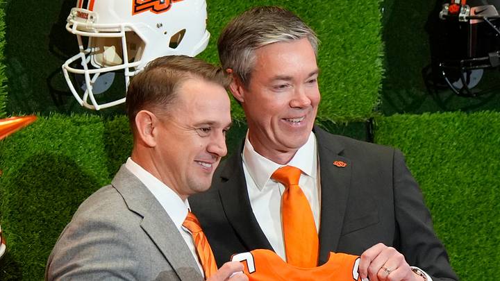 OSU Athletic Director Chad Weiberg presents a jersey to Eric Morris.