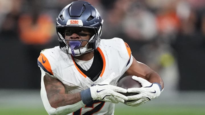 Dec 7, 2025; Paradise, Nevada, USA;  Denver Broncos running back RJ Harvey (12) carries the ball against the Las Vegas Raiders during the second half at Allegiant Stadium. 
