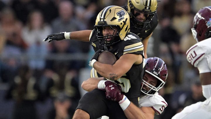 Purdue Boilermakers running back Devin Mockobee (45) is tackled Purdue Boilermakers running back Devin Mockobee (45) is tackled