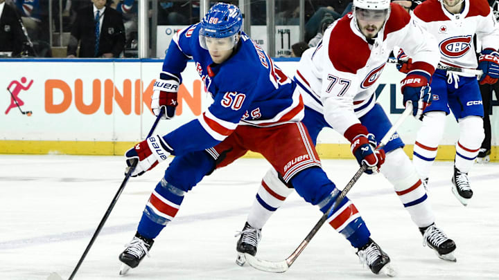 Nov 30, 2024; New York, New York, USA; New York Rangers left wing Will Cuylle (50) skates with the puck against Montreal Canadiens center Kirby Dach (77) during the third period at Madison Square Garden. Mandatory Credit: John Jones-Imagn Images