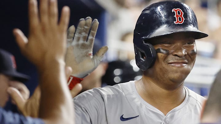 Boston Red Sox third baseman Rafael Devers (11)celebrates scoring against the Miami Marlins in the seventh inning at loanDepot Park.
