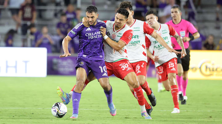 Aug 6, 2025; Orlando, FL, USA; Club Necaxa forward Ricardo Monreal (30) gets a yellow card on Orlando City midfielder Martin Ojeda (10) during the second half at Inter&Co Stadium. Mandatory Credit: Kim Klement Neitzel-Imagn Images