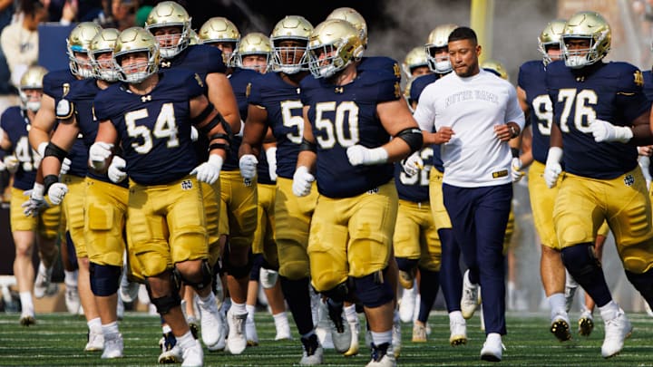 Notre Dame head coach Marcus Freeman runs out with his team before a NCAA college football game between Notre Dame and Stanford at Notre Dame Stadium on Saturday, Oct. 12, 2024, in South Bend.