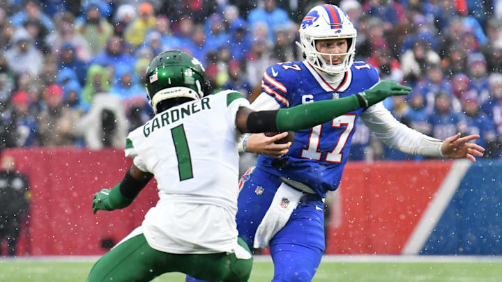Dec 11, 2022; Orchard Park, New York, USA; Buffalo Bills quarterback Josh Allen (17) makes a move on New York Jets cornerback Sauce Gardner (1) during a run in the second quarter at Highmark Stadium. Mandatory Credit: Mark Konezny-Imagn Images