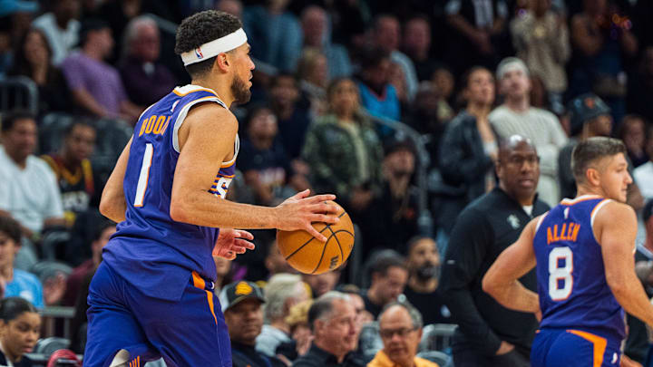Nov 10, 2024; Phoenix, Arizona, USA; Phoenix Suns guard Devin Booker (1) moves the ball down the court in overtime during a game against the Sacramento Kings at Footprint Center. Mandatory Credit: Allan Henry-Imagn Images