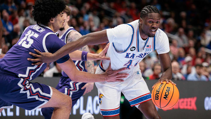 Mar 12, 2026; Kansas City, MO, USA; Kansas Jayhawks forward Flory Bidunga (40) drives to the basket around TCU Horned Frogs forward David Punch (15) during the first half at T-Mobile Center. Mandatory Credit: William Purnell-Imagn Images