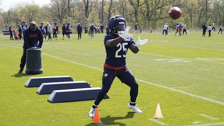 Kyle Monangai works on his hands under the watchful eye of backs coach Eric Bieniemy.