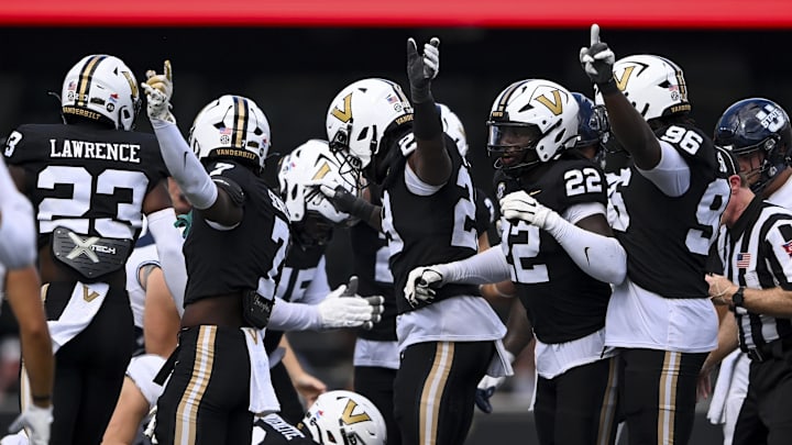 Sep 27, 2025; Nashville, Tennessee, USA;  Vanderbilt Commodores defense points after recovering the ball against the Utah State Aggies during the second half at FirstBank Stadium. Mandatory Credit: Steve Roberts-Imagn Images