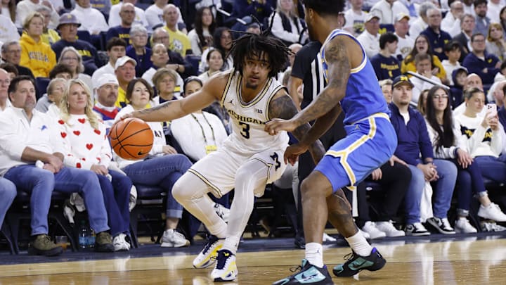 Feb 14, 2026; Ann Arbor, Michigan, USA; Michigan Wolverines guard Elliot Cadeau (3) dribbles defended by UCLA Bruins guard Donovan Dent (2) in the first half at Crisler Center. Mandatory Credit: Rick Osentoski-Imagn Images