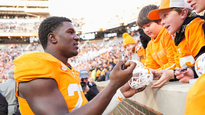 Tennessee defensive lineman James Pearce Jr. (27) autographs items for children after a college football game Tennessee defensive lineman James Pearce Jr. (27) autographs items for children after a college football game