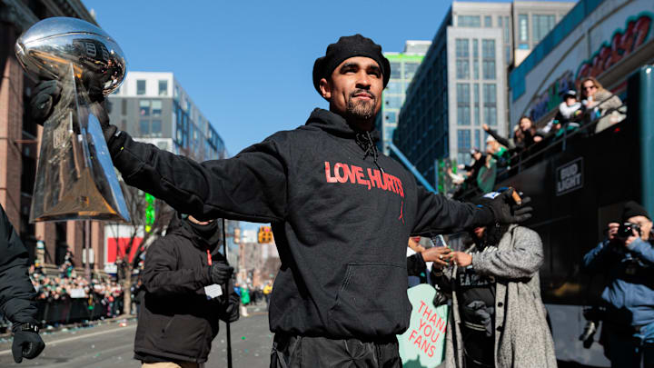 Philadelphia Eagles quarterback Jalen Hurts raises the Lombardi Trophy during the Super Bowl LIX championship parade.