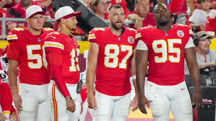 Aug 22, 2025; Kansas City, Missouri, USA; Kansas City Chiefs defensive end George Karlaftis (56) and quarterback Patrick Mahomes (15) and tight end Travis Kelce (87) and defensive tackle Chris Jones (95) watch play against the Chicago Bears during the second half of the game at GEHA Field at Arrowhead Stadium. Mandatory Credit: Denny Medley-Imagn Images