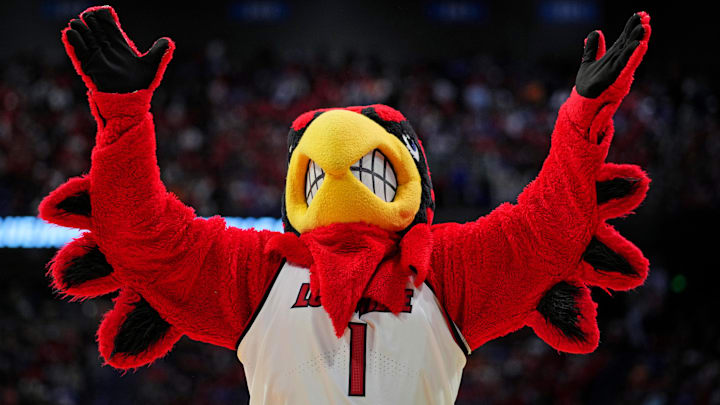 Mar 20, 2025; Lexington, KY, USA; The Louisville Cardinals mascot cheers during the second half against the Creighton Bluejays in the first round of the NCAA Tournament at Rupp Arena. Mandatory Credit: Aaron Doster-Imagn Images