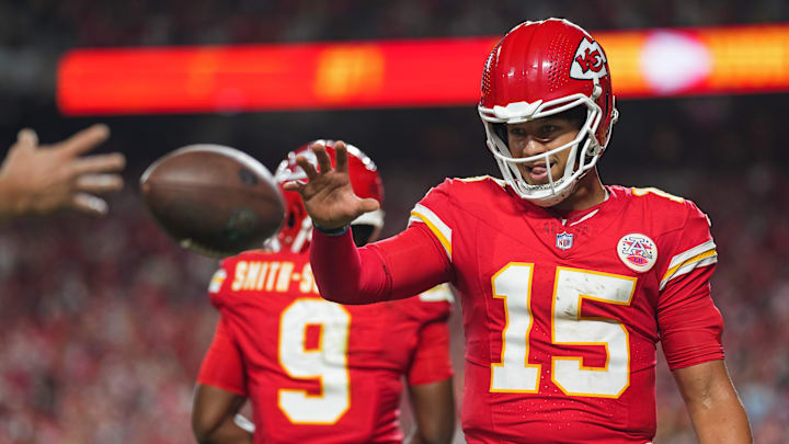 Sep 5, 2024; Kansas City, Missouri, USA; Kansas City Chiefs starting quarterback Patrick Mahomes (15) retrieves a touchdown ball belonging to wide receiver Xavier Worthy (not pictured) during the second half against the Baltimore Ravens at GEHA Field at Arrowhead Stadium. Mandatory Credit: Jay Biggerstaff-Imagn Images
