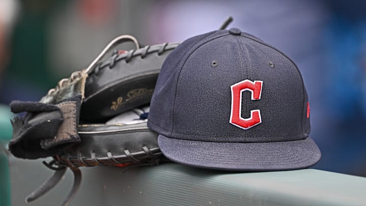 Jun 27, 2024; Kansas City, Missouri, USA; A general view a Cleveland Guardians hat and glove on the dugout railing before a game against the Kansas City Royals at Kauffman Stadium. Mandatory Credit: Peter Aiken-Imagn Images Jun 27, 2024; Kansas City, Missouri, USA; A general view a Cleveland Guardians hat and glove on the dugout railing before a game against the Kansas City Royals at Kauffman Stadium. Mandatory Credit: Peter Aiken-Imagn Images