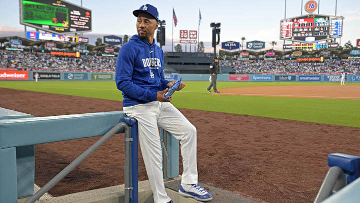 Apr 10, 2026; Los Angeles, California, USA; Los Angeles Dodgers shortstop Mookie Betts (50) looks on from the dugout steps during the game against the Texas Rangers at Dodger Stadium. Mandatory Credit: Jayne Kamin-Oncea-Imagn Images