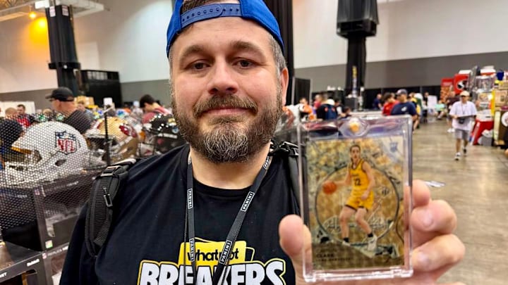 Cary Williams holds the Panini Silver Pack 1/1 Caitlin Clark card he pulled at the 2024 National Sports Collectors Convention