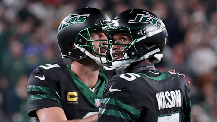 Oct 31, 2024; East Rutherford, New Jersey, USA; New York Jets quarterback Aaron Rodgers (8) and wide receiver Garrett Wilson (5) watch a video replay of their touchdown against the Houston Texans during the fourth quarter at MetLife Stadium. Mandatory Credit: Brad Penner-Imagn Images