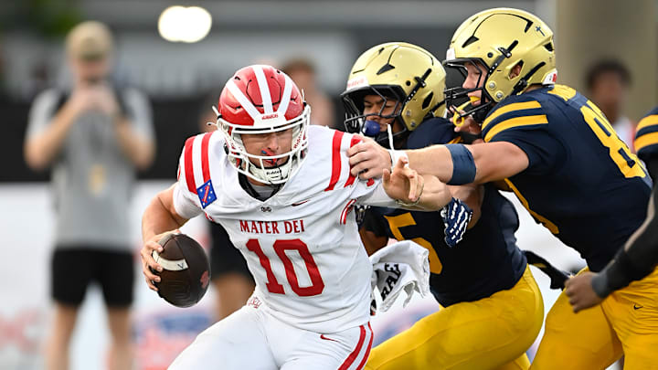 The St. Thomas defense applies some heavy pressure to Mater Dei quarterback Ryan Hopkins.