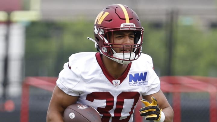 Jun 5, 2024; Ashburn, VA, USA; Washington Commanders running back Austin Ekeler (30) carries the ball during OTA workouts at Commanders Park. Mandatory Credit: Geoff Burke-USA TODAY Sports Jun 5, 2024; Ashburn, VA, USA; Washington Commanders running back Austin Ekeler (30) carries the ball during OTA workouts at Commanders Park. Mandatory Credit: Geoff Burke-USA TODAY Sports